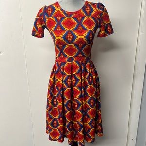 LuLaRoe short sleeve dress with back zip in bright red, blue and yellow.